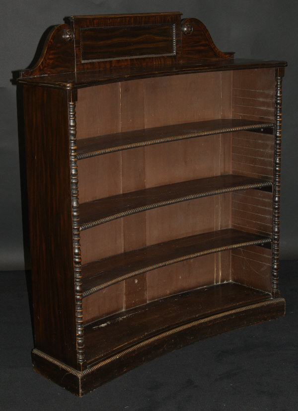 A 19th Century faux rosewood four tier bookcase of concave form,