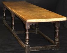 A circa 1650 oak single plank top refectory table, the underneath bearing two dished salt bowls,