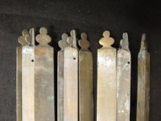 Nine 19th Century brass stair rods with stylised club ends,