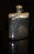 An early 20th Century silver-plated hip flask of large proportions, initialled "MEJ" to front,