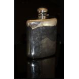 An early 20th Century silver-plated hip flask of large proportions, initialled "MEJ" to front,