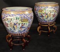 A pair of 20th Century Chinese porcelain polychrome decorated fish bowls decorated with panels of