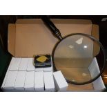 A box containing twelve 20 x 21mm jeweller's loupes and a large wooden handled magnifying glass*