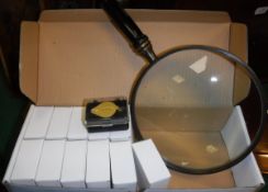 A box containing twelve 20 x 21mm jeweller's loupes and a large wooden handled magnifying glass*