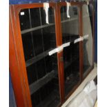 A three door mahogany and glazed display cabinet of narrow form,