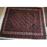 A Caucasian rug the central panels set with a large lozenge shaped medallion decorated with hook