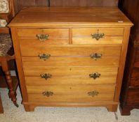 An Edwardian satin walnut chest of two short above three long drawers to bracket feet