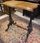 A Victorian walnut centre table on turned and carved end supports and stretchered base