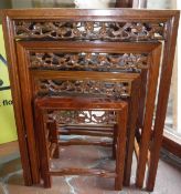 A modern Chinese quartetto nest of cherry wood occasional tables with carved decoration