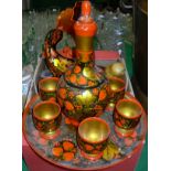 A box of lacquered and painted wares including Indian candlesticks,