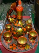 A box of lacquered and painted wares including Indian candlesticks,