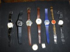 A collection of nine various watches bearing various names to include Swatch, Gucci, Rolex,