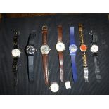 A collection of nine various watches bearing various names to include Swatch, Gucci, Rolex,