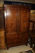 A 19th Century mahogany linen press, the top with dentil decoration above two doors,