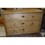 A Continental pine commode of three drawers,