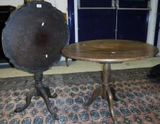 A mahogany dished top tilt-top tea table on turned pedestal to three cabriole legs to claw and ball