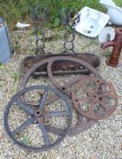 Three cast iron wheels/handles together with a cast iron trough and two horse shoe stands