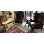 A pair of modern Thomas Lloyd upholstered wing back scroll arm chairs on cabriole legs in the