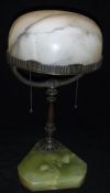An early 20th Century table lamp with domed white alabaster shade raised on a bronzed Y shaped