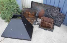 A cast iron fire back with coat of Arms together with various cast iron fire baskets,
