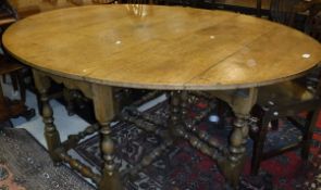 A 20th Century oak dining table in the 18th Century manner,