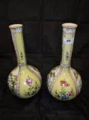 A pair of Dresden yellow ground gourd shaped vases decorated with figures in garden settings