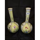 A pair of Dresden yellow ground gourd shaped vases decorated with figures in garden settings