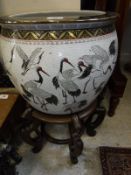 A 20th Century Chinese porcelain fish bowl decorated with storks,