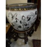 A 20th Century Chinese porcelain fish bowl decorated with storks,