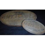 A reproduction painted cast iron "Antiques" sign and another similar smaller*