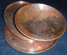 A Newlyn copper plate with beaten decoration stamped "Newlyn",