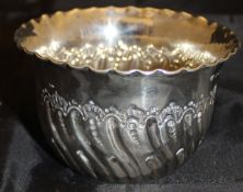 A Victorian silver sugar bowl with embossed decoration (Sheffield 1888)
