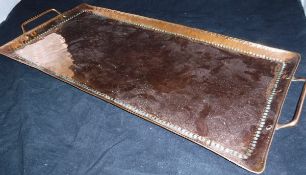 A Newylyn School rectangular beaten copper tray, stamped to base "J.