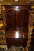 A mahogany bureau bookcase with two glazed doors enclosing shelves,