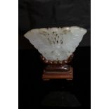 A carved Chinese jade butterfly plaque with carved hardwood stand