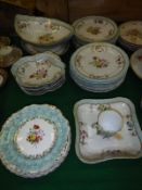 A 19th Century Continental hand-painted and gilt decorated dessert service with basket weave edging,