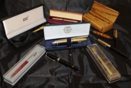 A box containing assorted pens to include a Mont Blanc fountain pen, No.