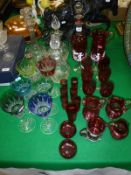 A collection of cranberry glassware including a pair of Mary Gregory style goblets,