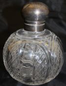 An Edwardian scent bottle with silver mounts and cut glass body,