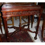 A modern mahogany occasional table with galleried top,