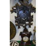 A Black Forest or Alpine style cuckoo clock with carved decoration and a Junghans mantle clock in a