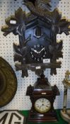 A Black Forest or Alpine style cuckoo clock with carved decoration and a Junghans mantle clock in a