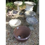 A collection of five composite stone garden urns,