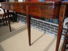 A 19th Century mahogany serving table, the single piece shallow bow fronted top over three drawers,