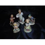 A collection of four Goebel Hummel figures,