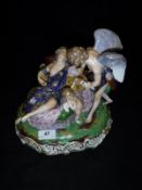 A Derby figural group of a winged figure blood letting recumbent maiden whilst Cupid looks on
