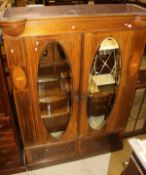 An Edwardian mahogany and inlaid wardrobe, the two mirrored doors above two drawers,