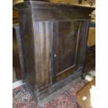 A 17th Century Dutch oak cabinet of plain form with single panelled door enclosing shelves with