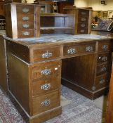 A mahogany desk with assorted drawers and shelves to the super structure with blue tooled leather