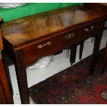 A mahogany fold-over tea table in the George III taste with single drawer on square chamfered and